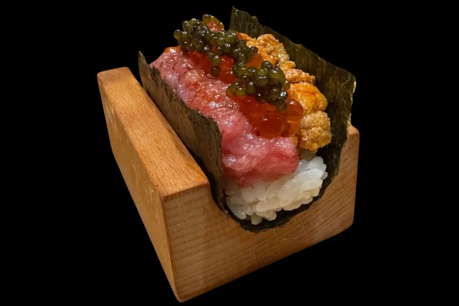 Kiwami hand roll — toro, uni and ikura in a wooden stand against black