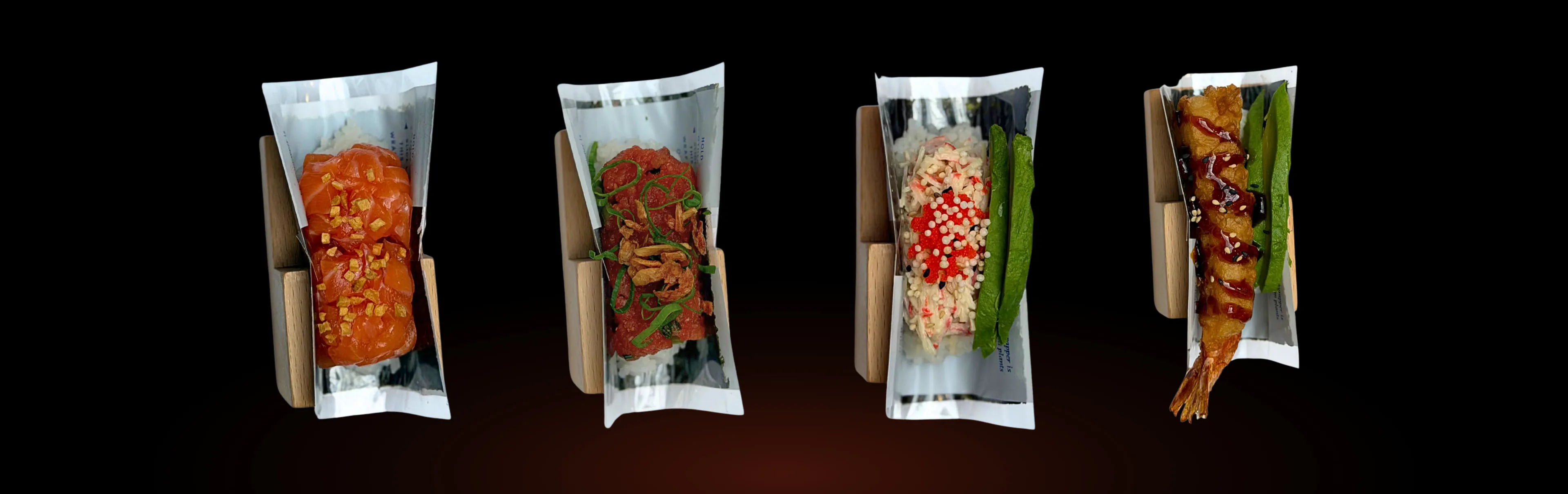 Salmon, spicy tuna, California and shrimp tempura hand rolls spread across a black ground